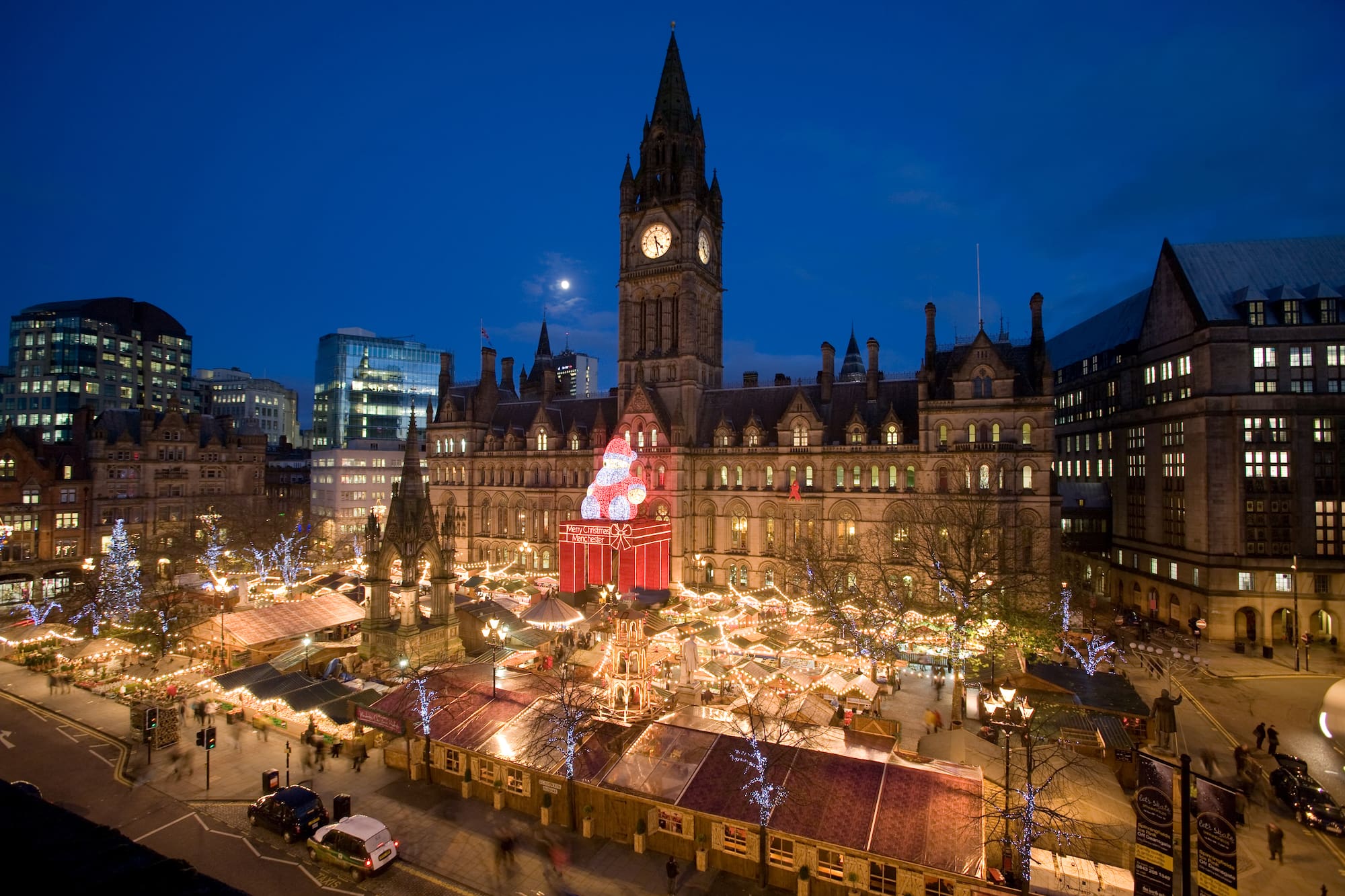 a large building with a clock tower and christmas lights