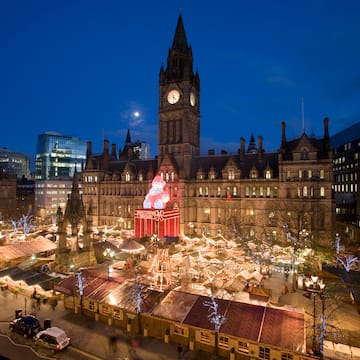 a large building with a clock tower and christmas lights