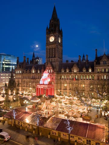 a large building with a clock tower and christmas lights