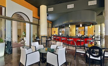 a room with a bar and a man sitting at the counter