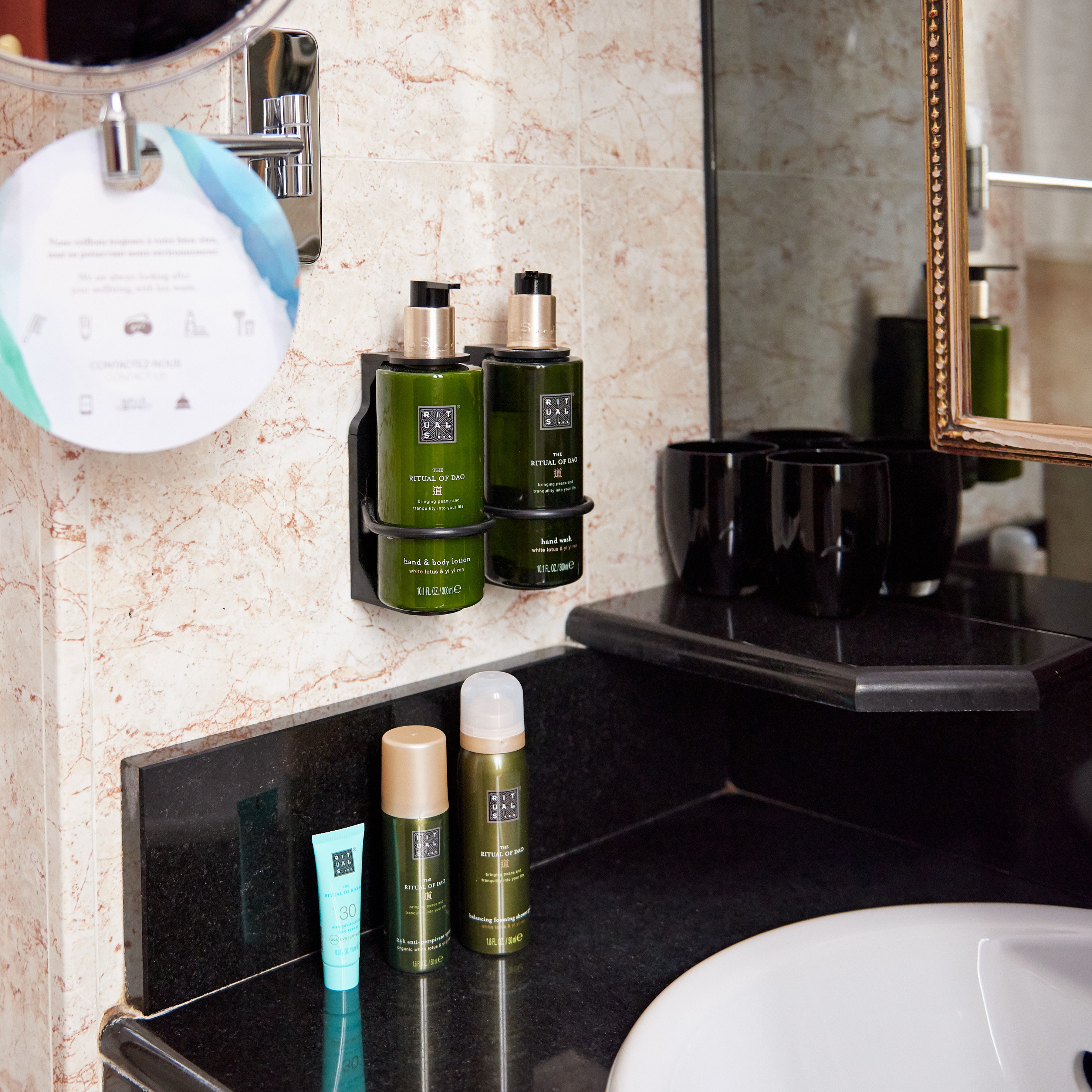 Rituals of Dao bathroom amenities: wall-mounted hand wash, body lotion, and shower gel.