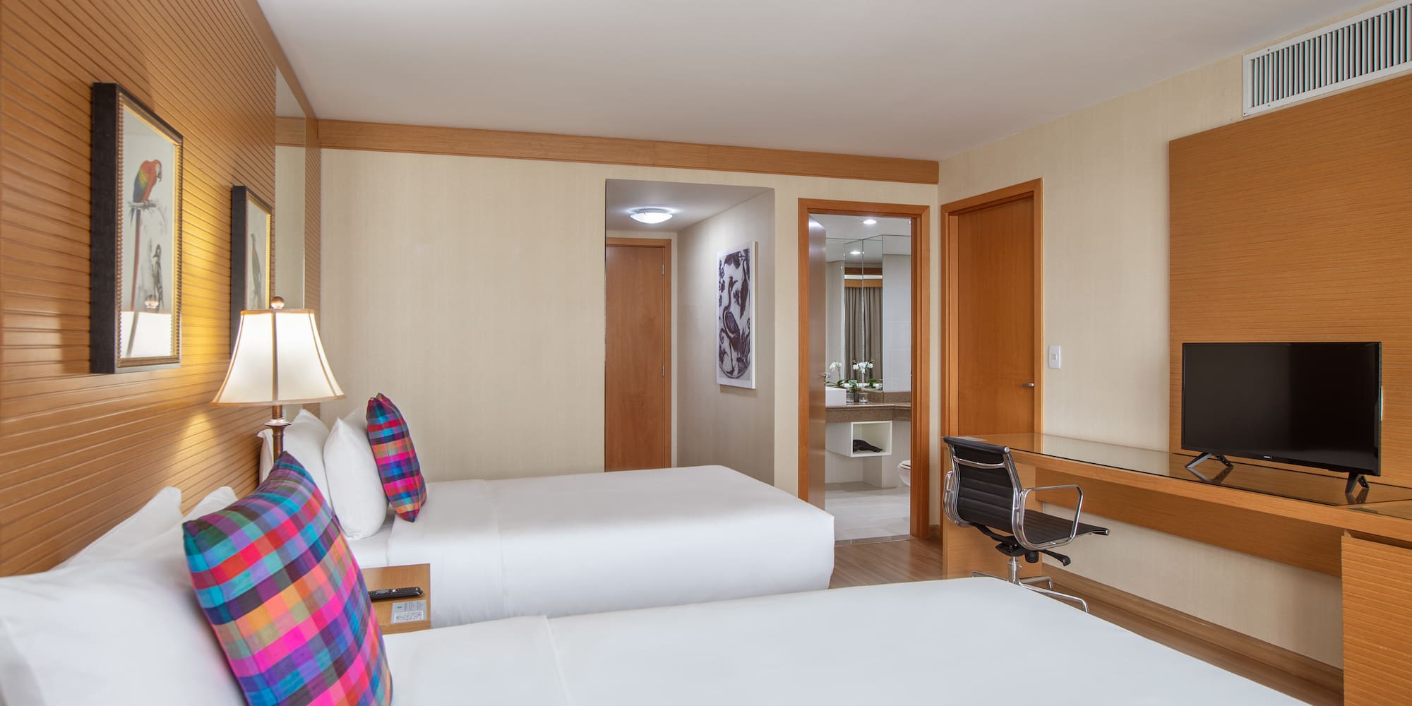 a room with two beds and a mirror