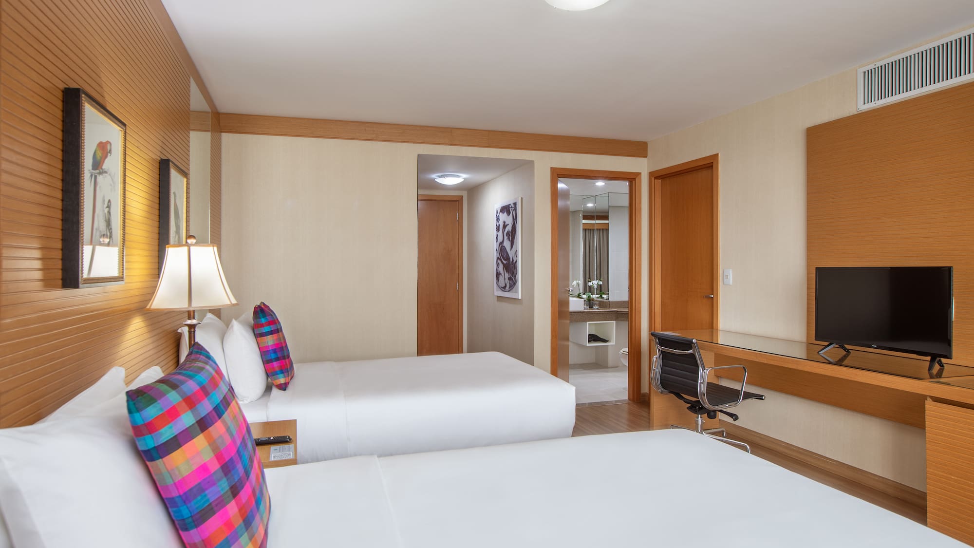 a room with two beds and a mirror