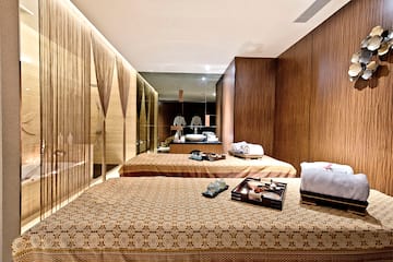 a room with beds and towels