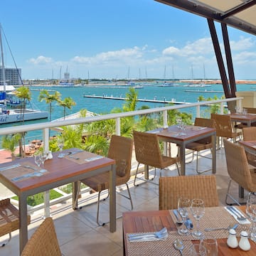 a restaurant with a view of the water and boats