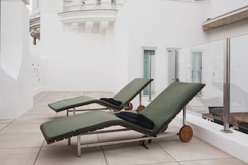a couple of lounge chairs on a patio