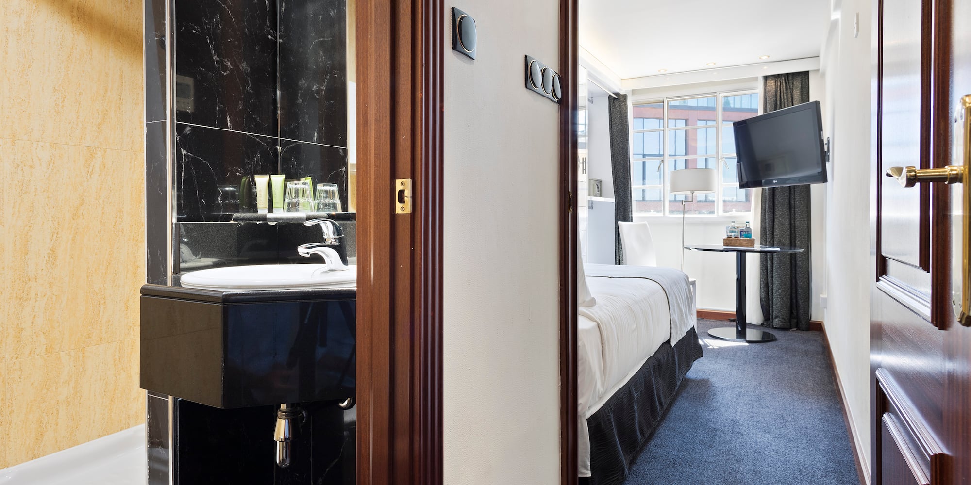 a room with a sink and a bed