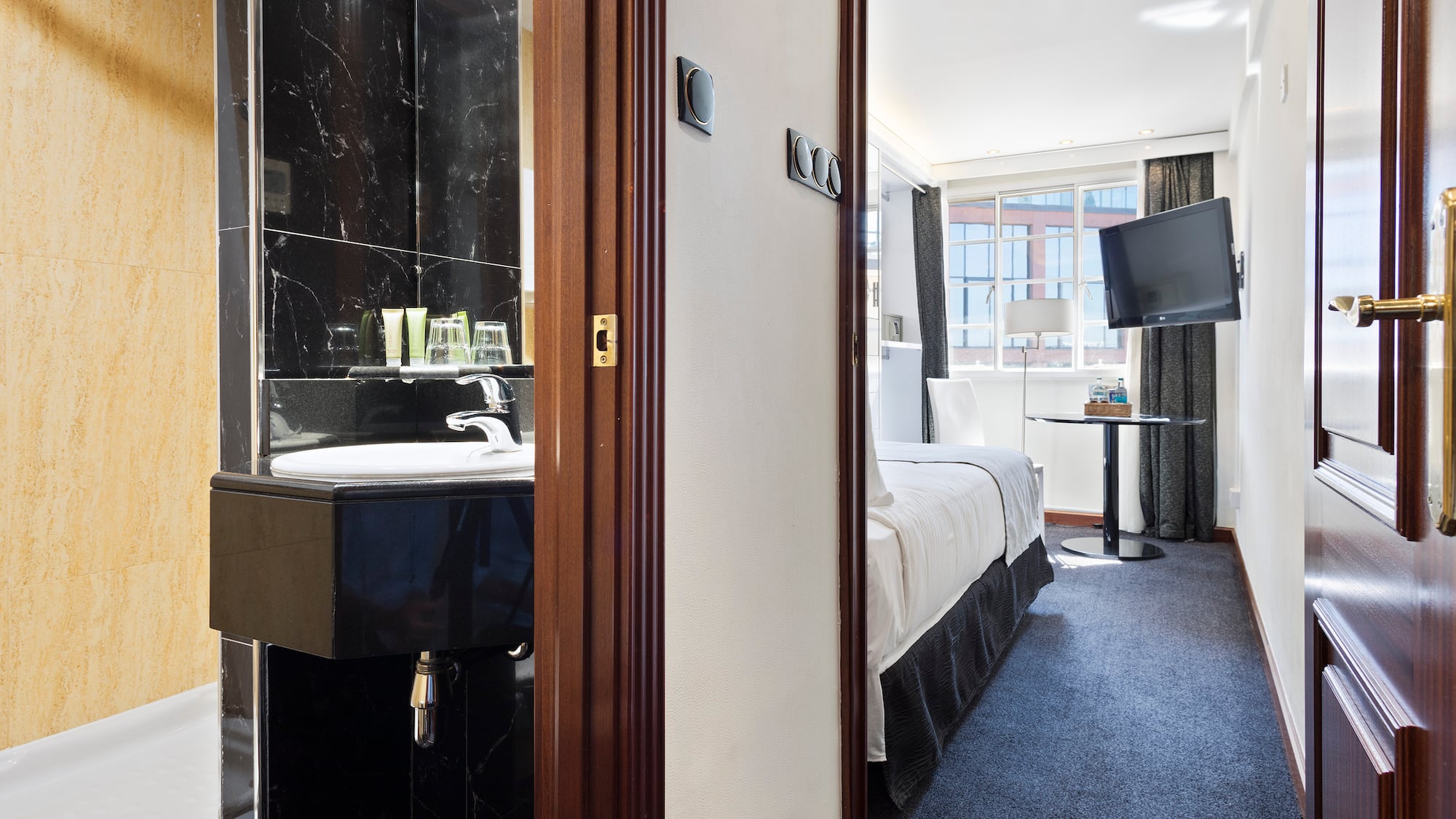 a room with a sink and a bed