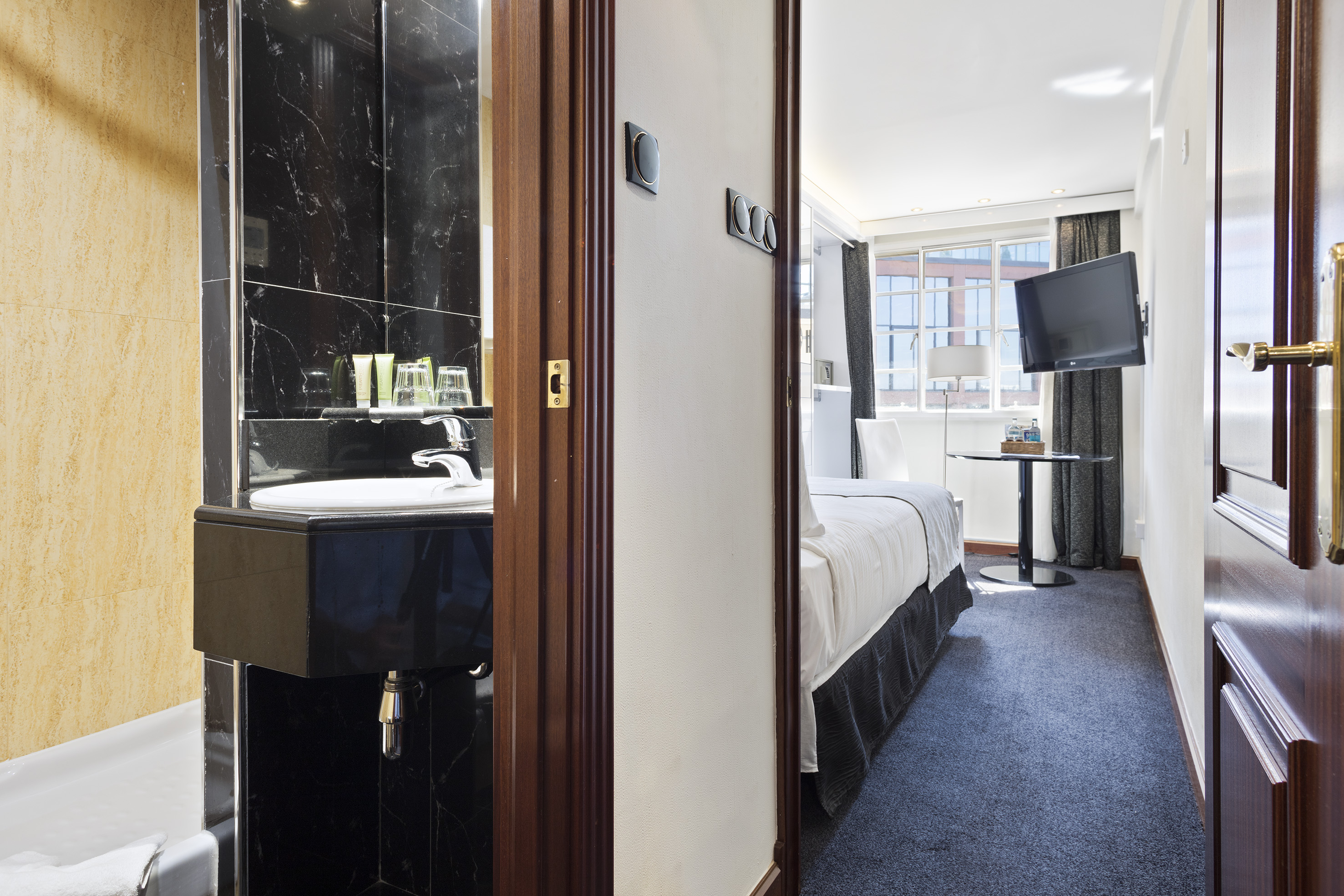 a room with a sink and a bed