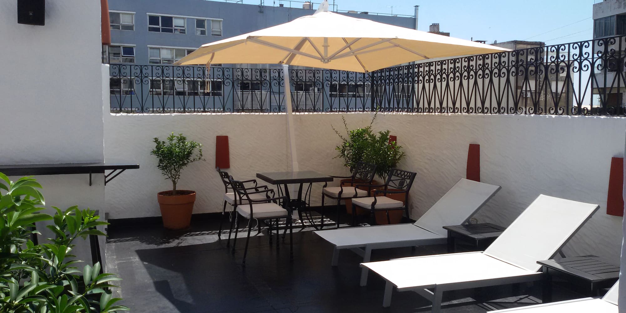 a patio with chairs and umbrella