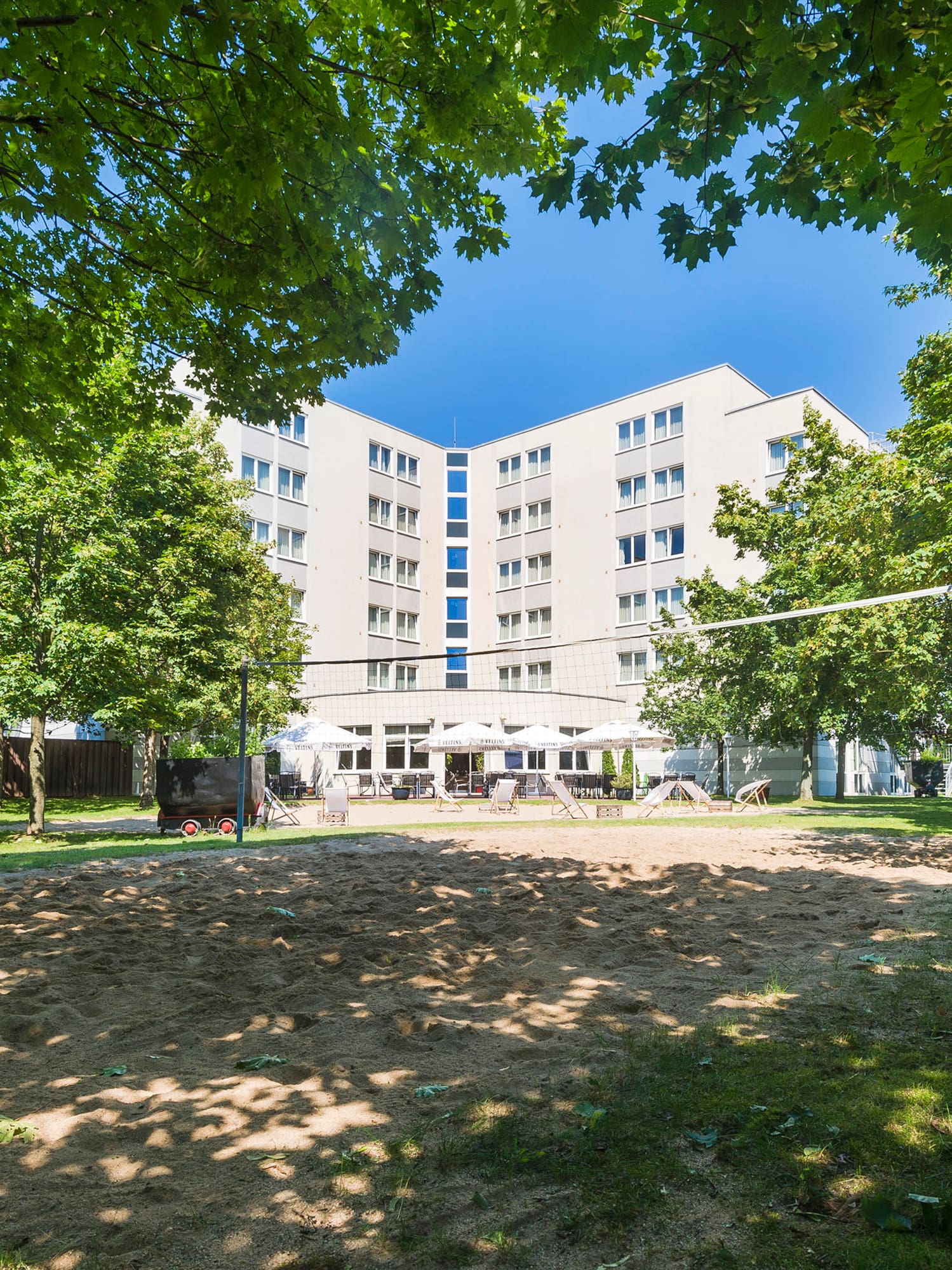 a building with a volleyball net in the background