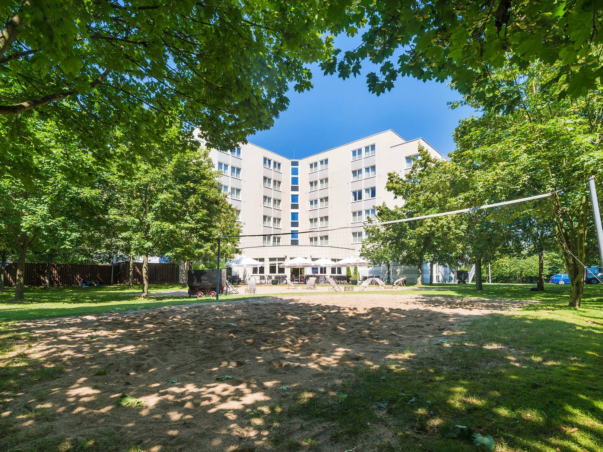 a building with a volleyball net in the background