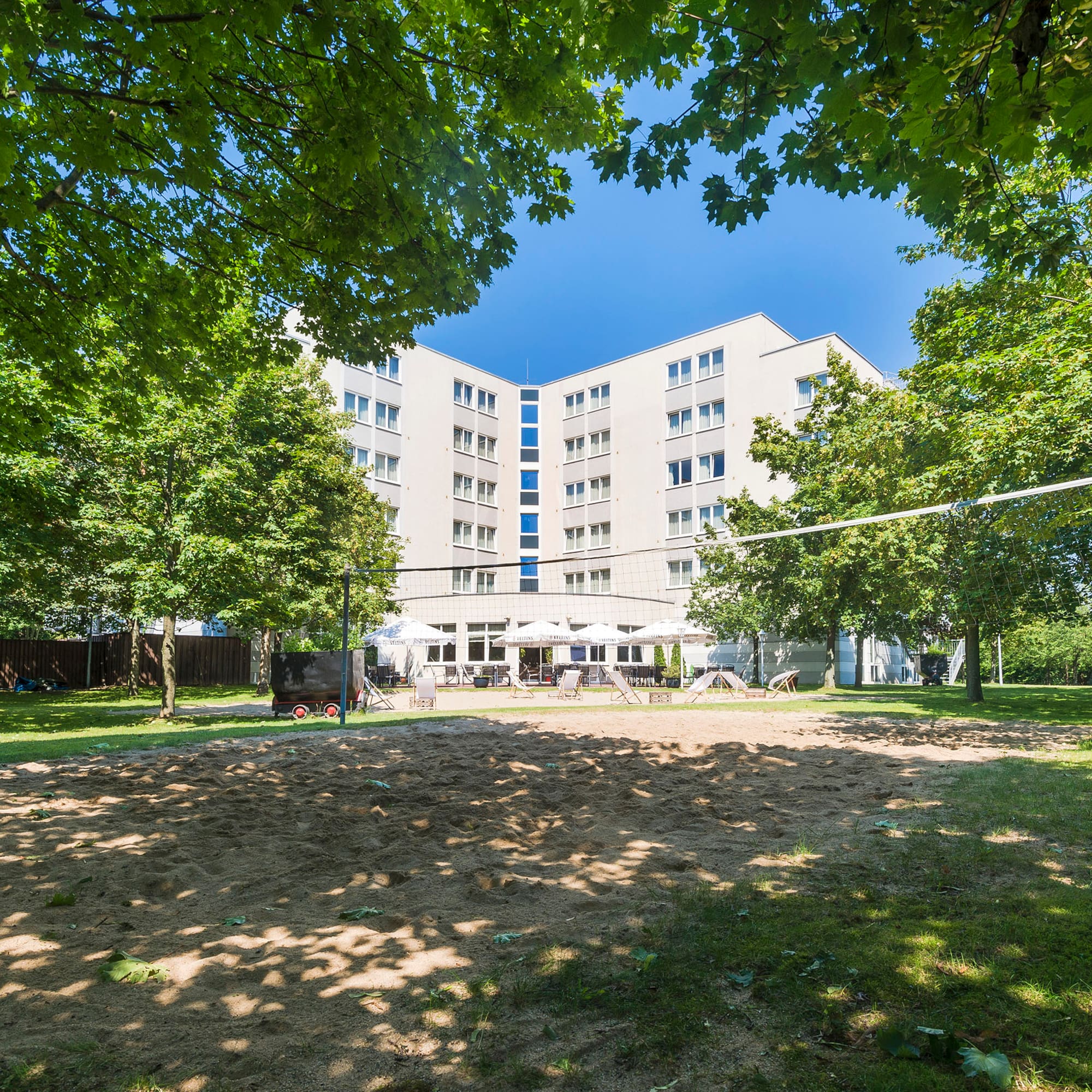 a building with a volleyball net in the background