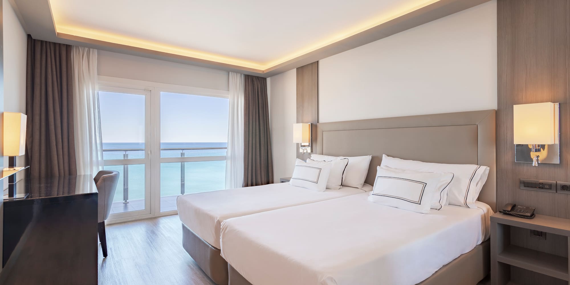 a room with two beds and a desk