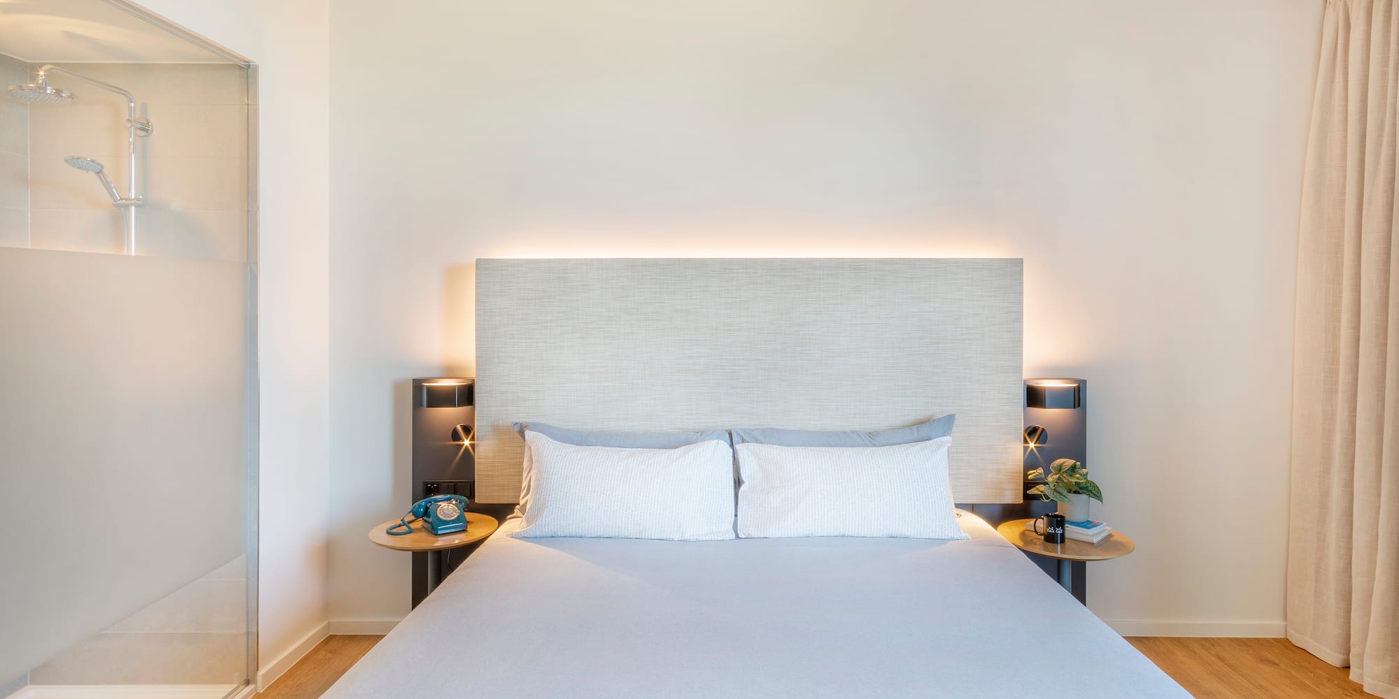 a bed with a headboard and two nightstands