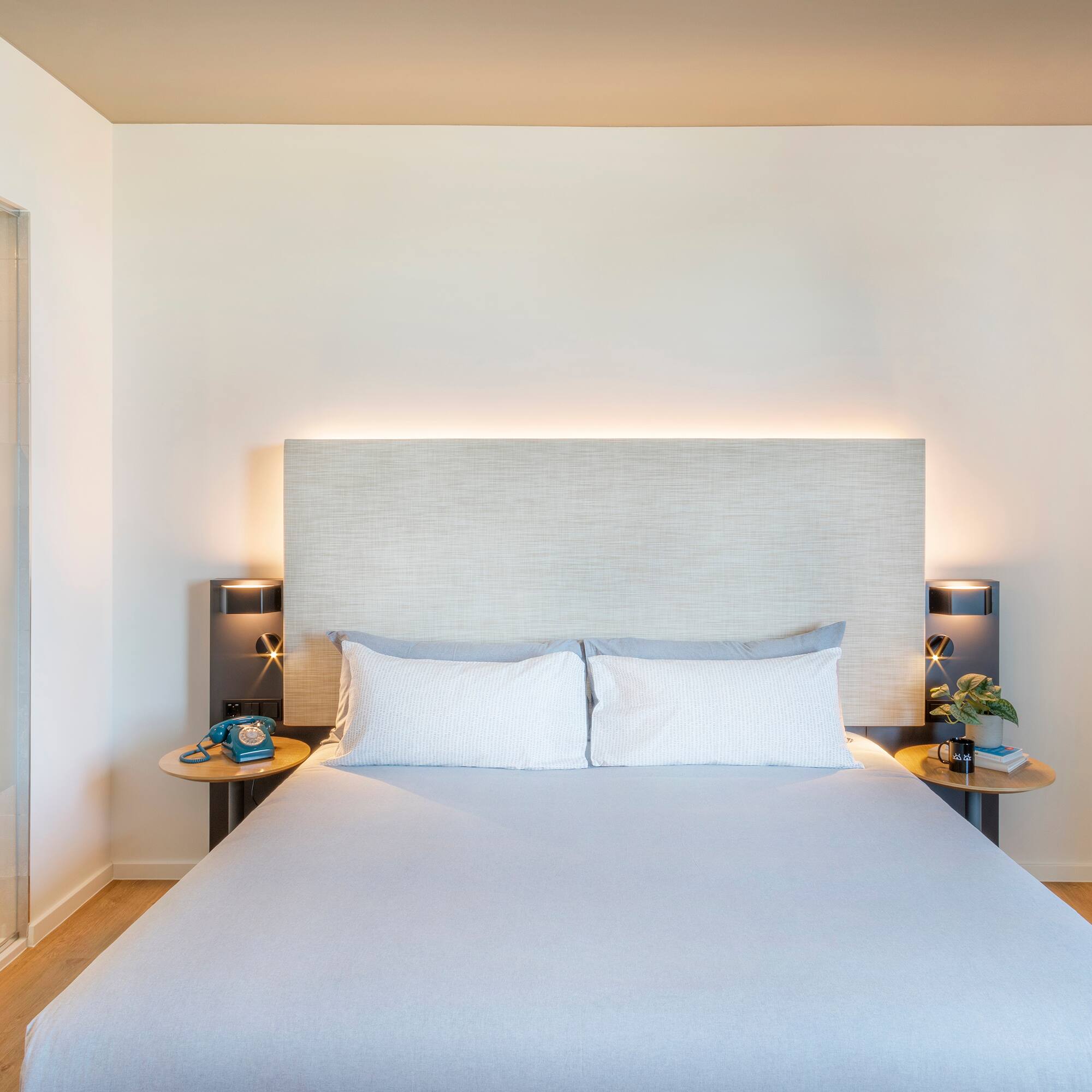 a bed with a headboard and two nightstands