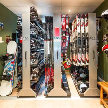 a room with snowboards and helmets