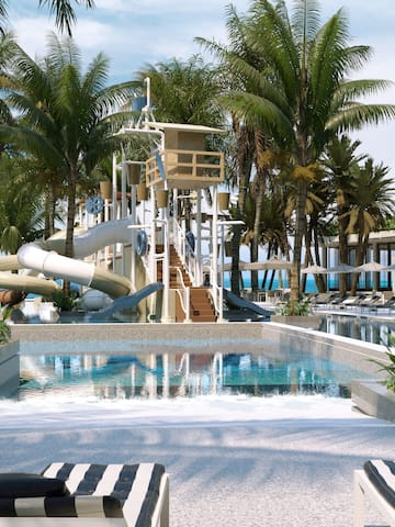 a pool with a water slide and palm trees