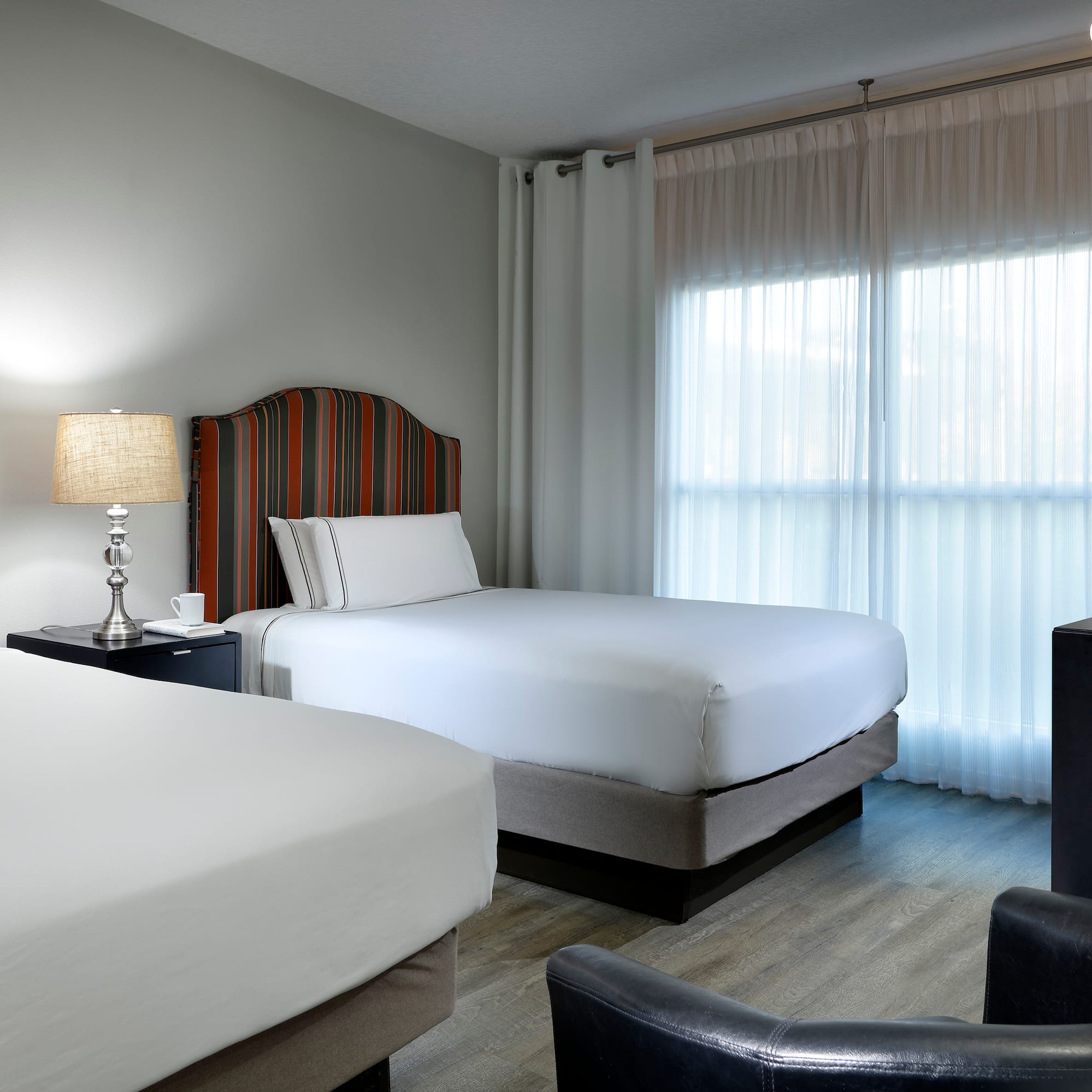 a room with two beds and a lamp