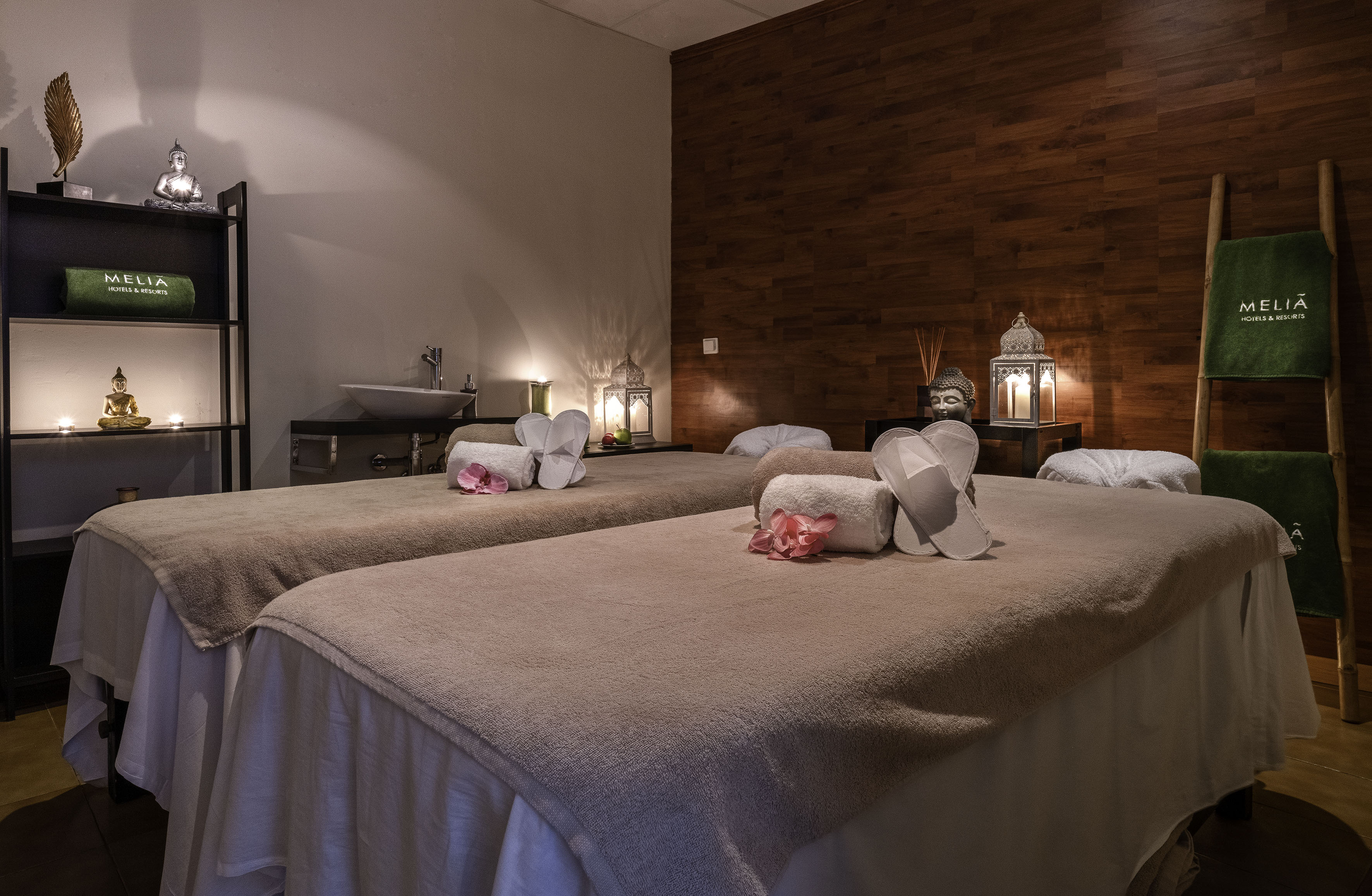 Tranquil Melia spa room with two massage beds, warm ambiance, and wellness decor.