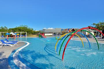 a pool with colorful water slides and a slide