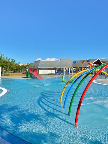 a pool with colorful water slides and a slide