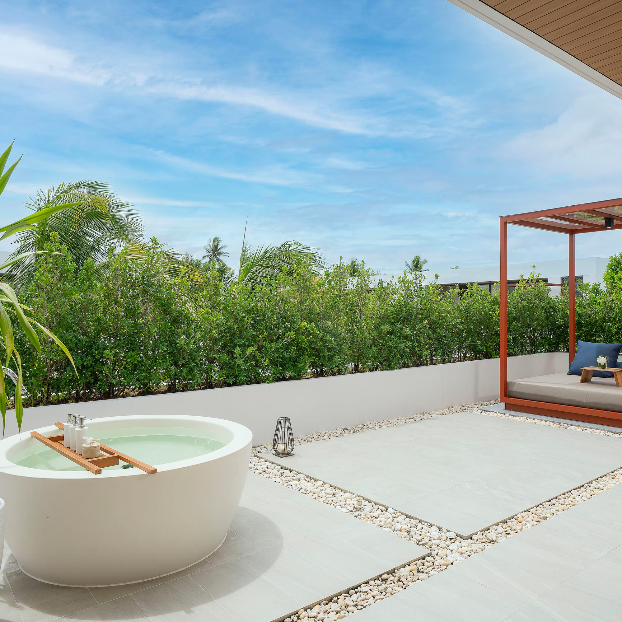 a patio with a tub and a bed