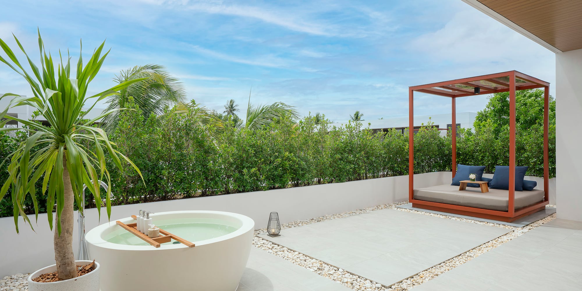 a patio with a tub and a bed