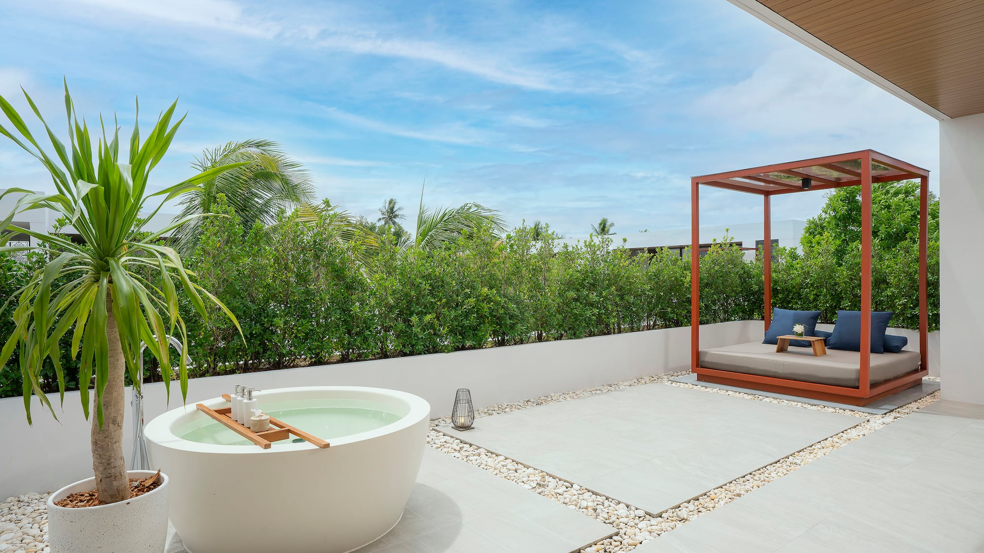 a patio with a tub and a bed