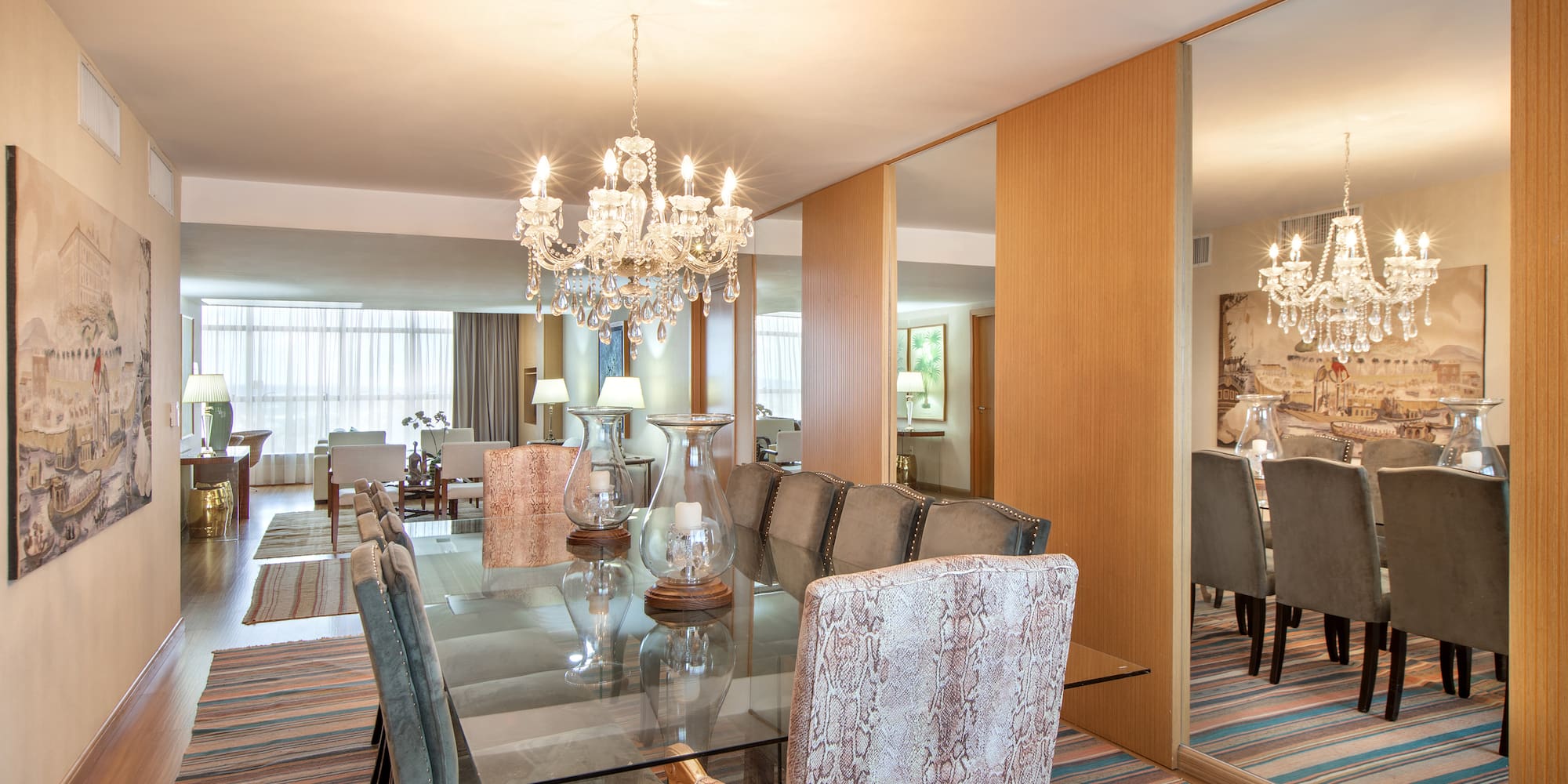 a dining room with a chandelier and a glass table