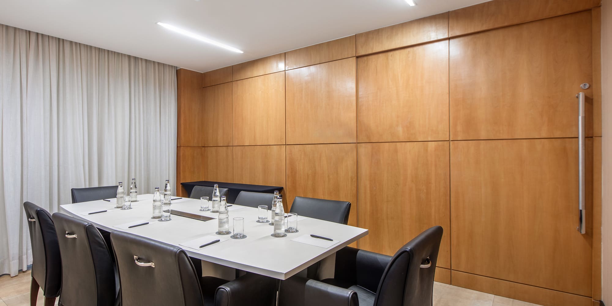 a table with chairs and bottles on it