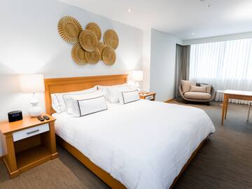 a bedroom with a bed and a chair