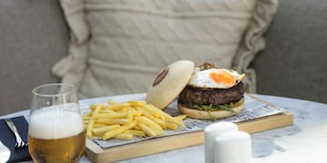 a burger and fries on a tray