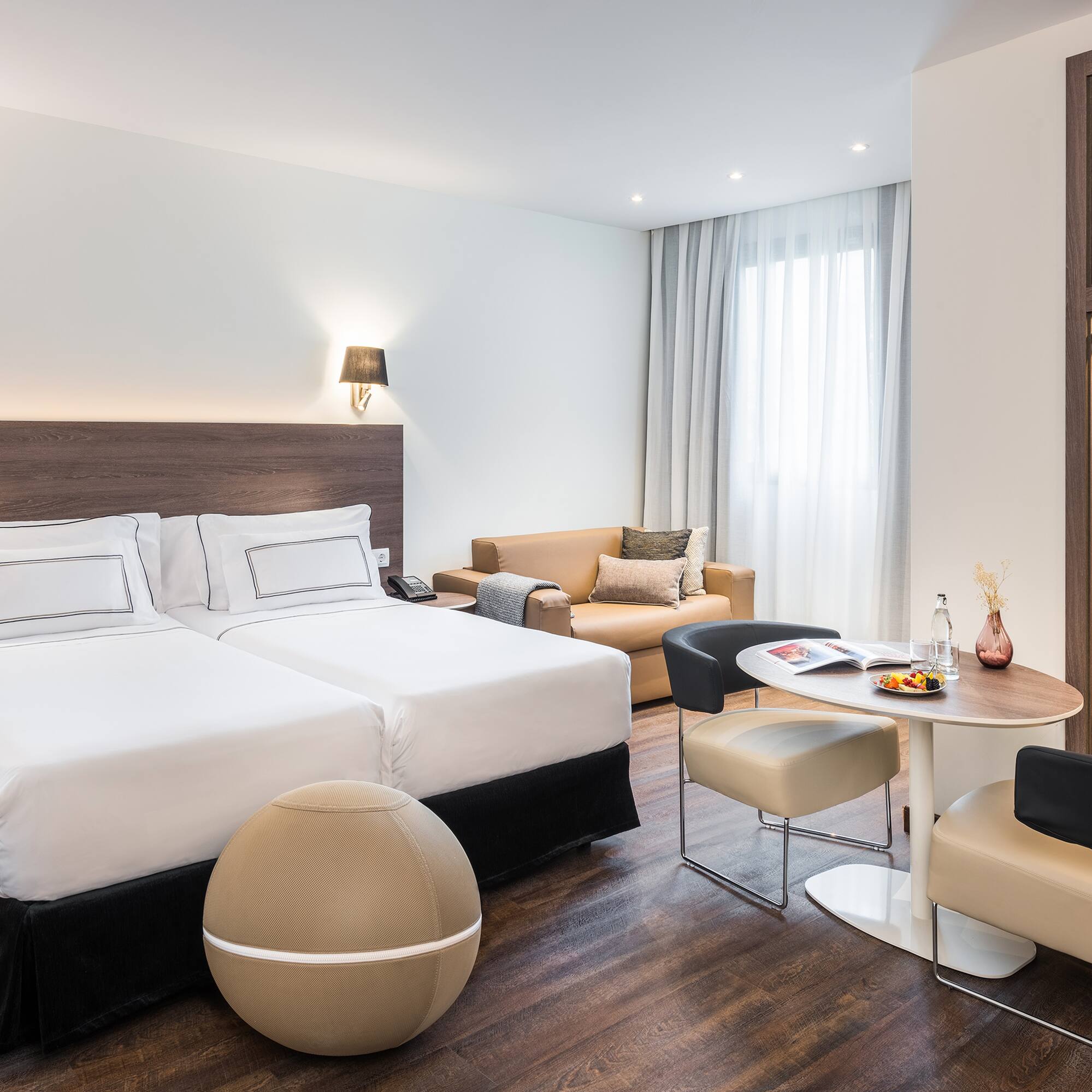 a room with two beds and a table