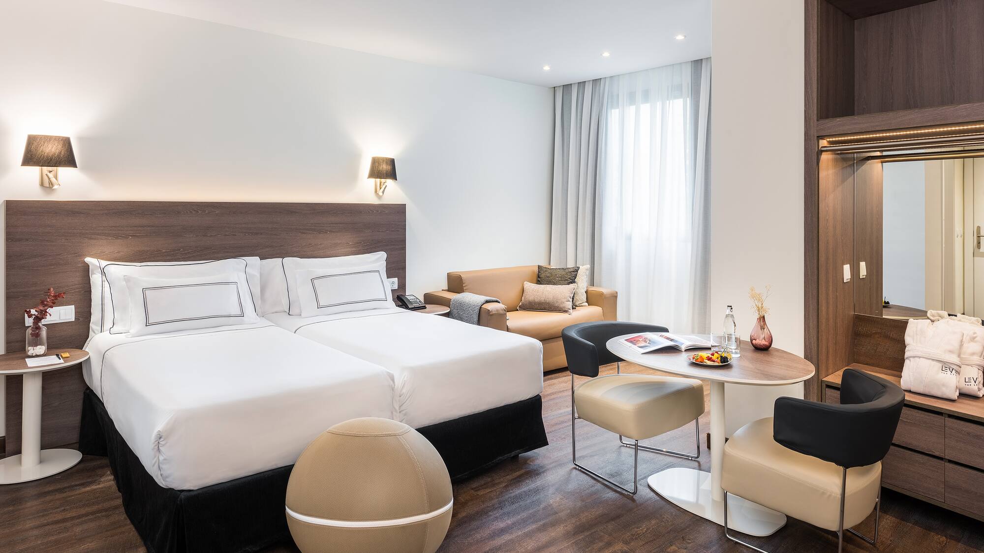 a room with two beds and a table