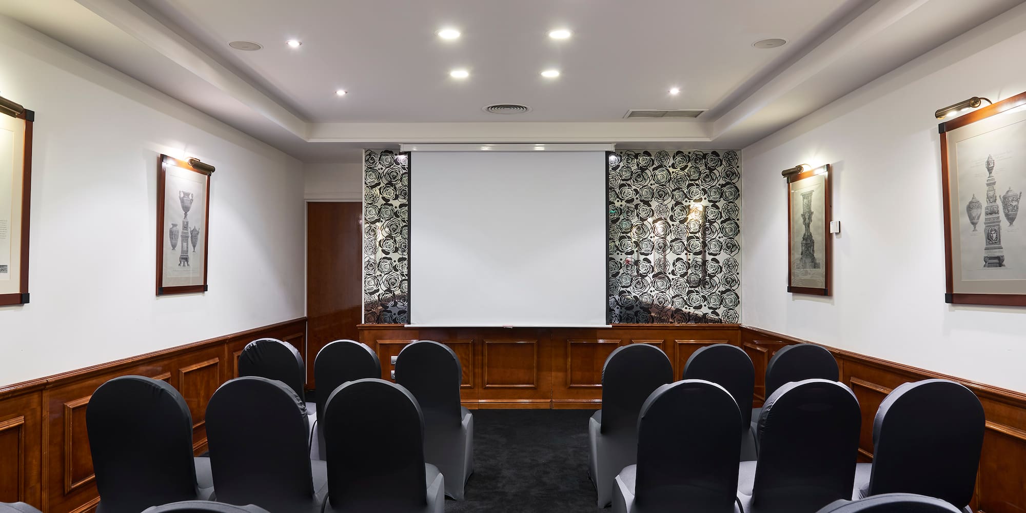 a room with chairs and a projector screen