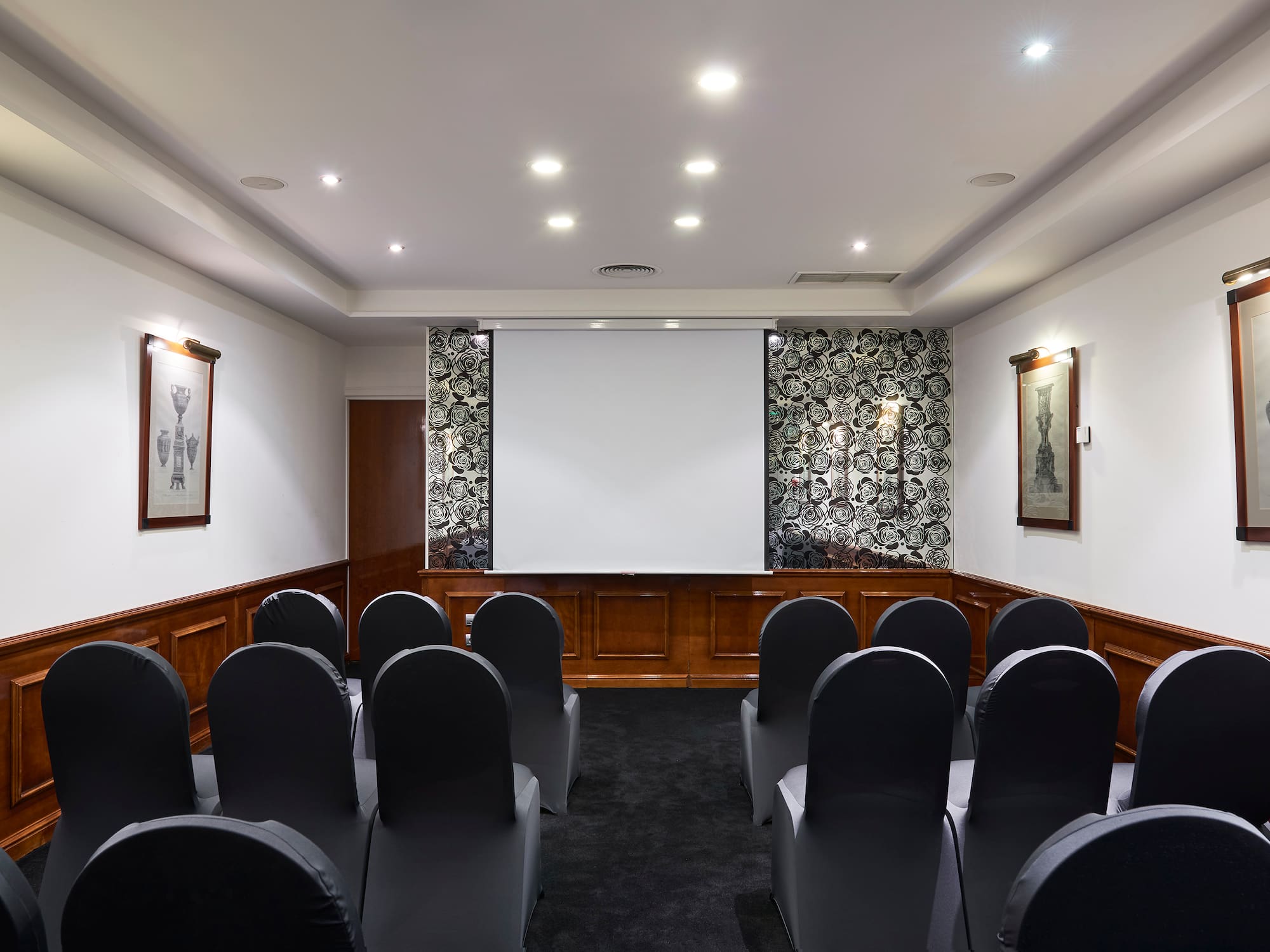 a room with chairs and a projector screen