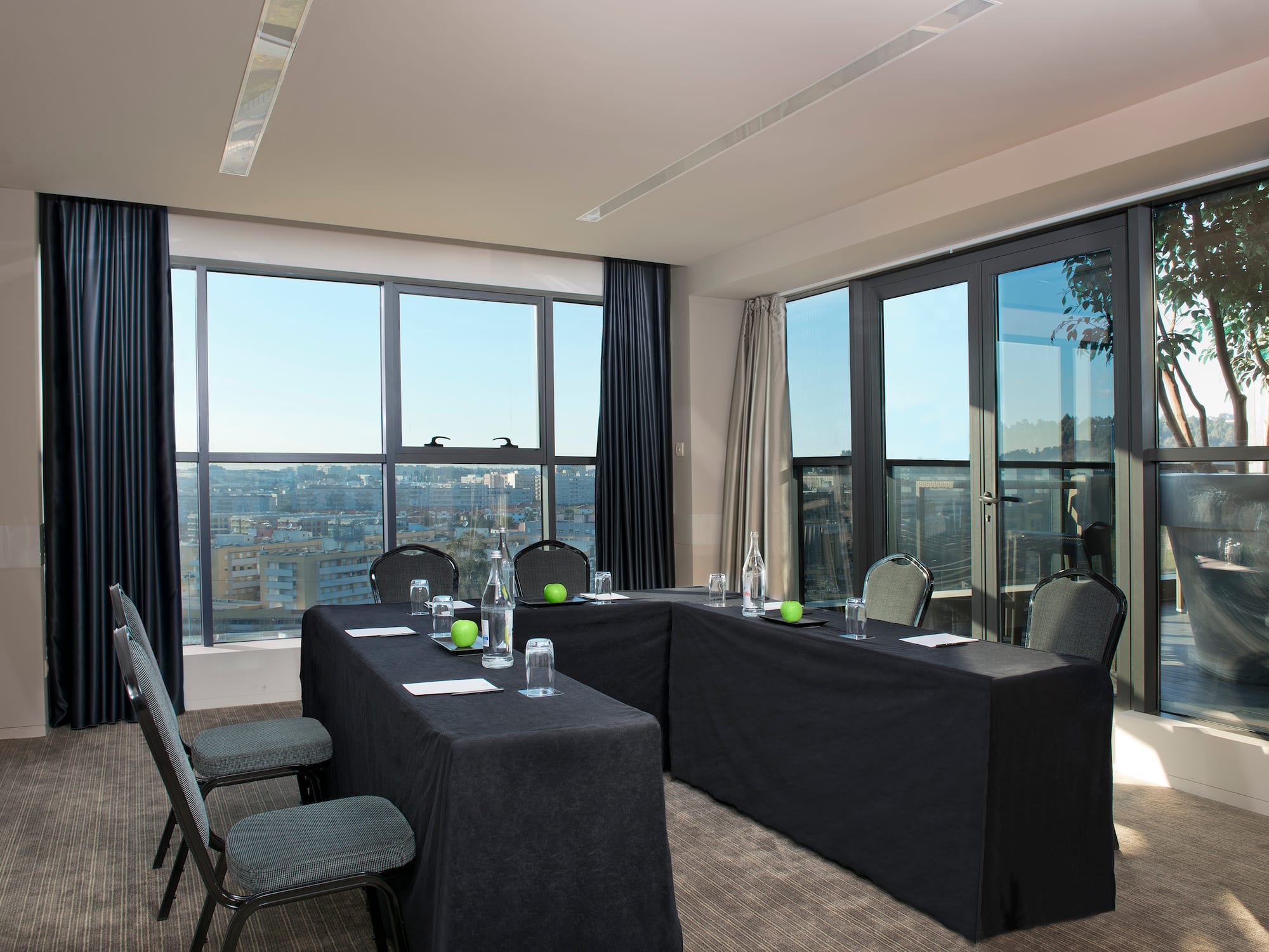 a room with black table cloths and chairs