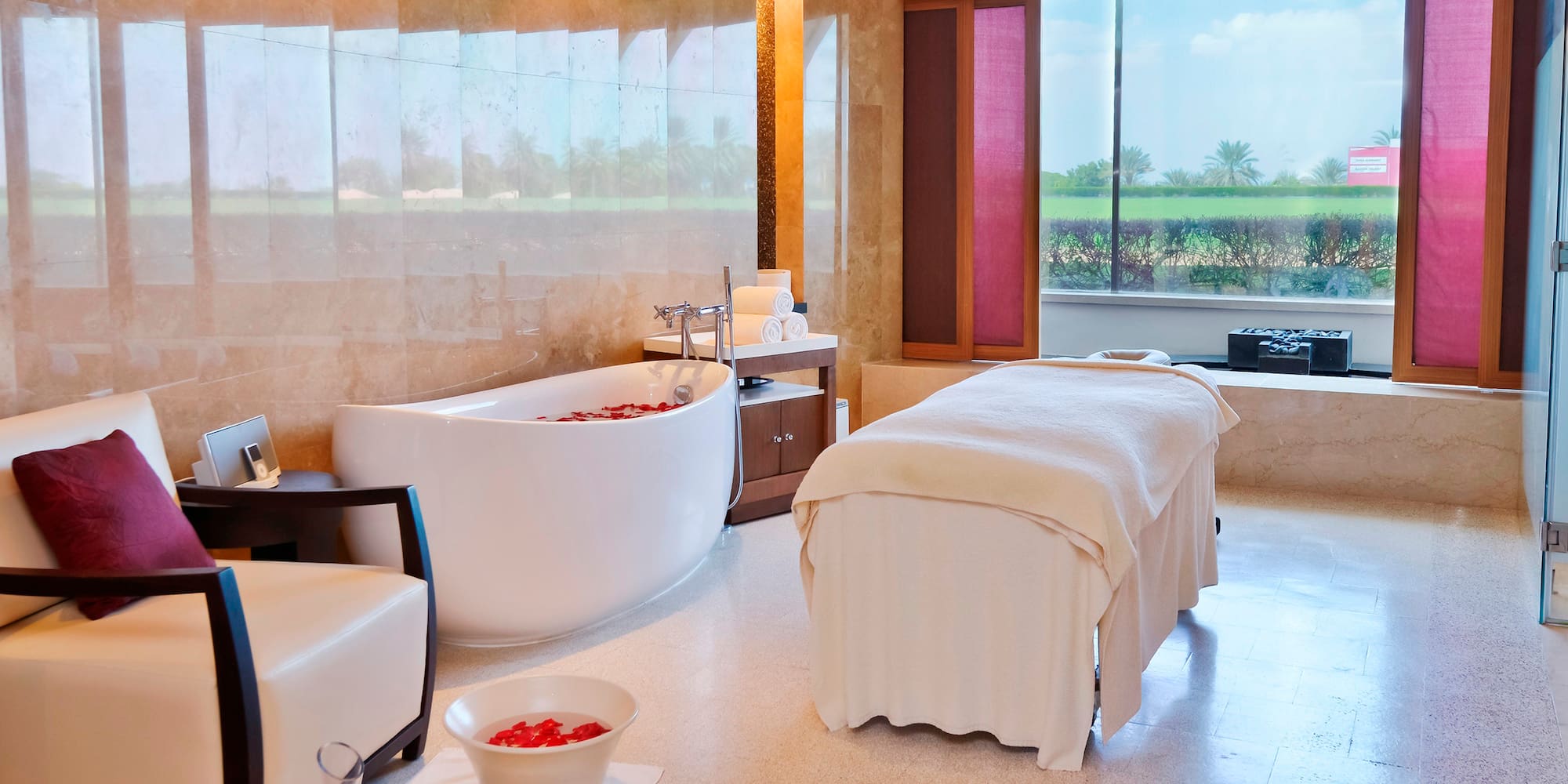 a room with a bathtub and chairs