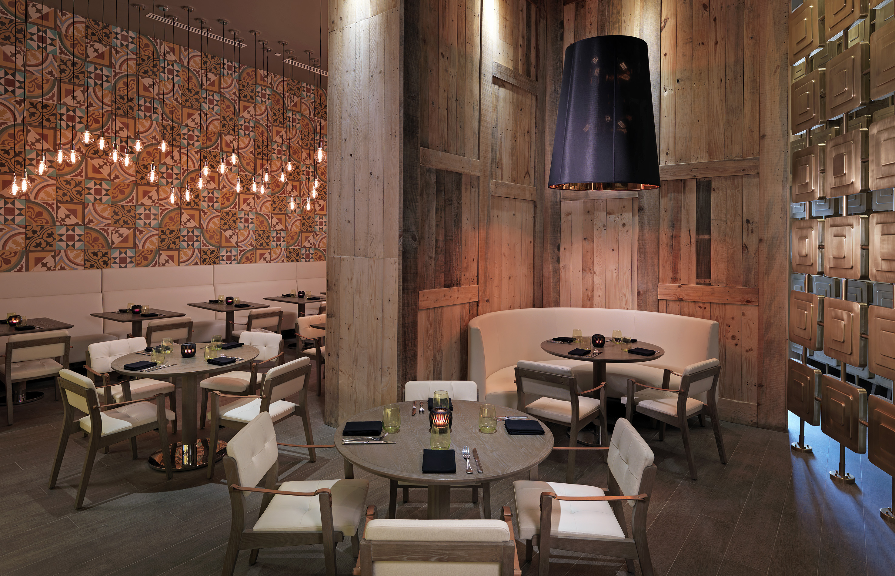 Stylish restaurant with rustic wood, patterned tiles, and modern pendant lights.
