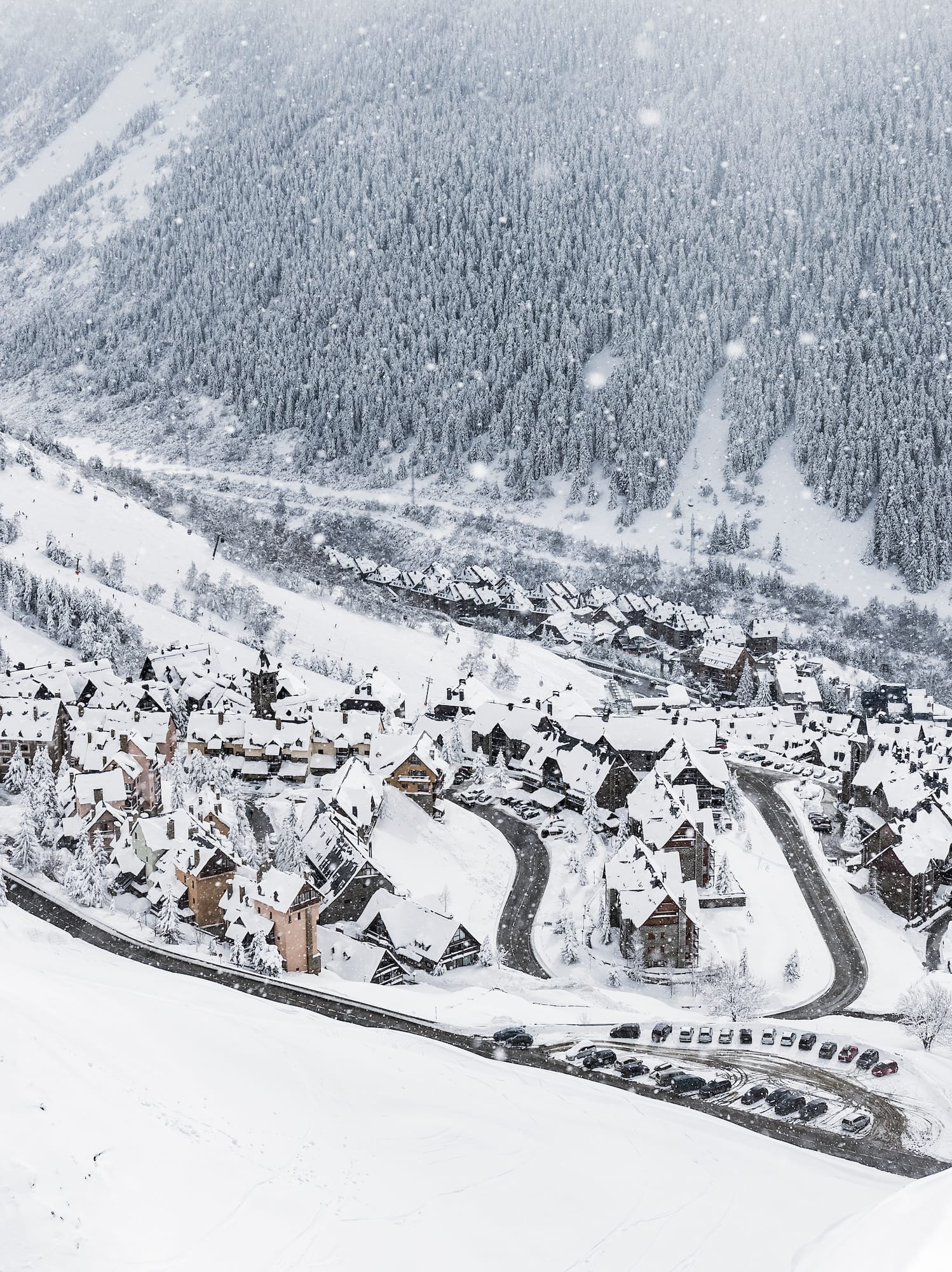 a snowy mountain with houses and trees
