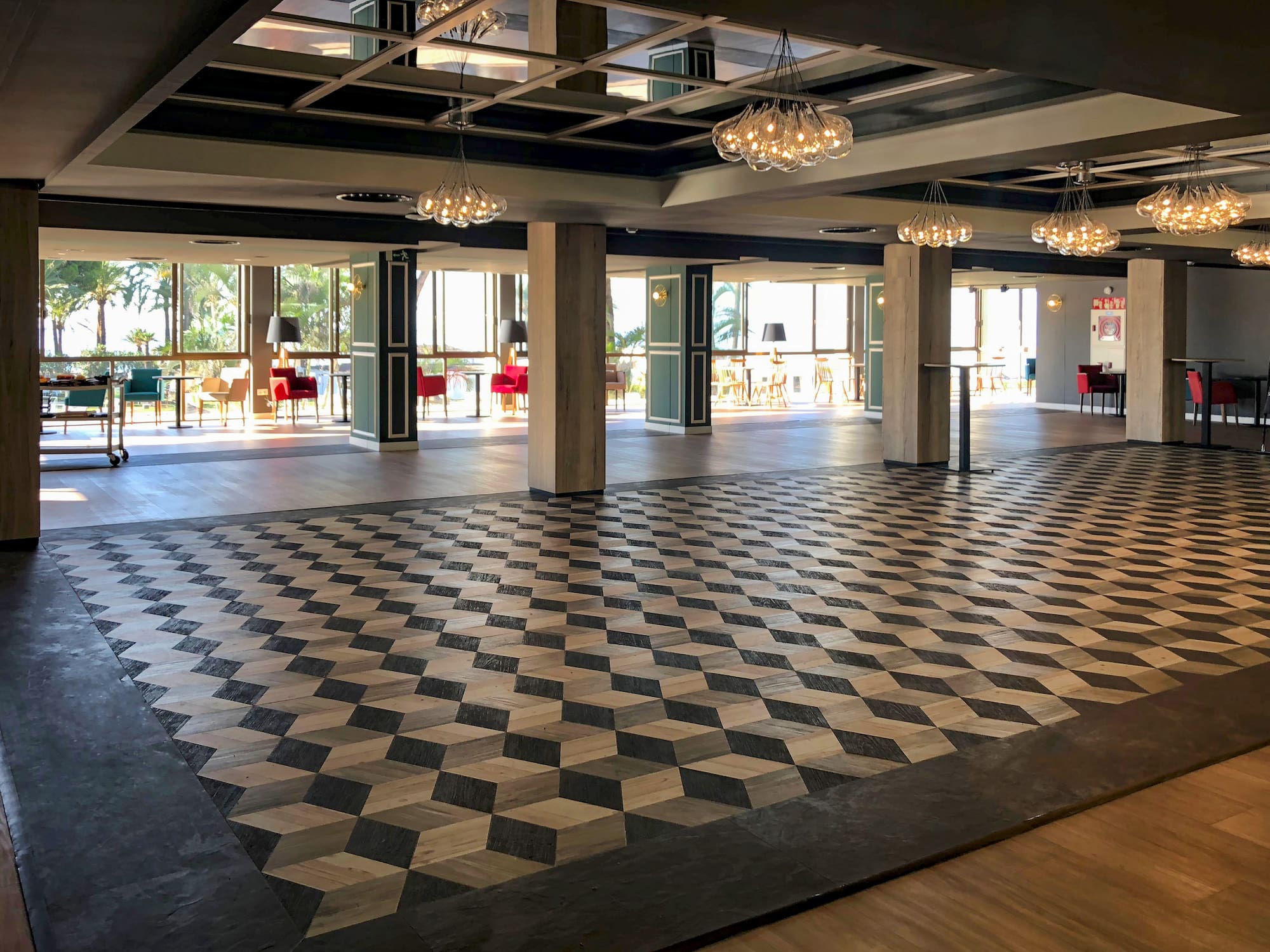 a large room with a checkered floor and chandeliers