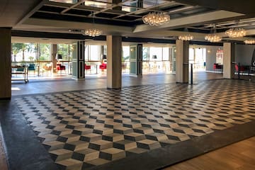 a large room with a checkered floor and chandeliers