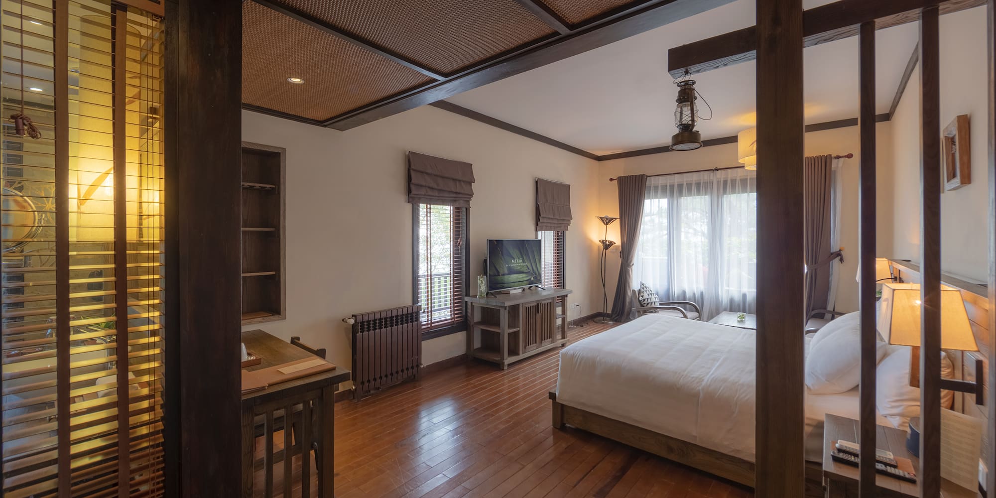 a bedroom with a wood floor and a wood floor