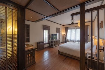 a bedroom with a wood floor and a wood floor