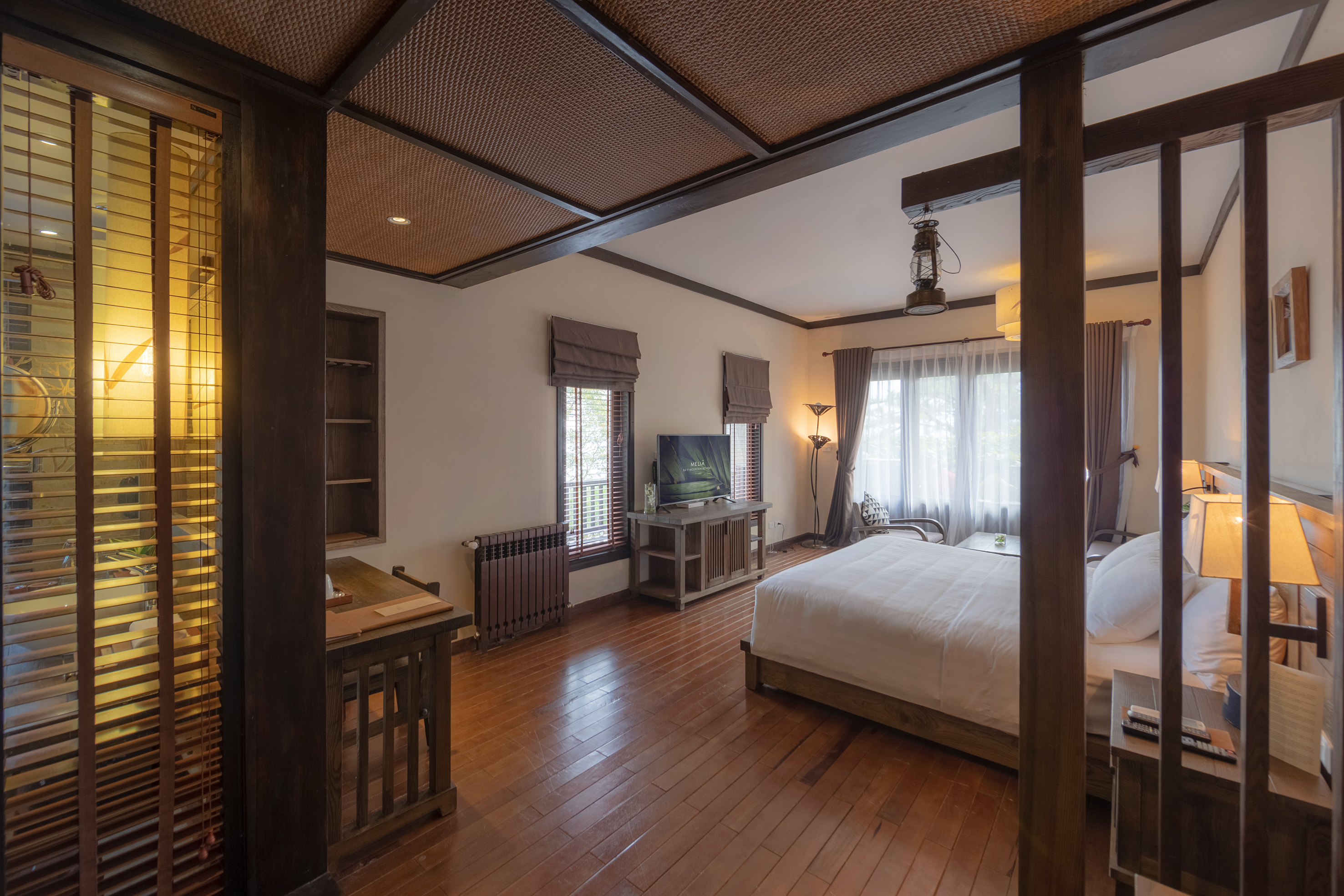 a bedroom with a wood floor and a wood floor