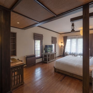 a bedroom with a wood floor and a wood floor