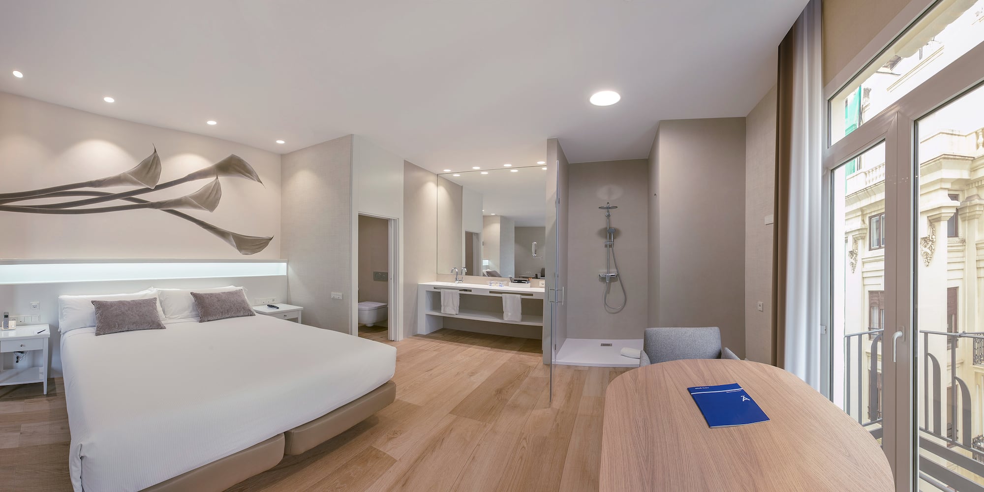 a room with a bed and a wood floor