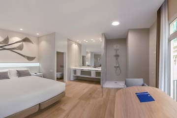 a room with a bed and a wood floor