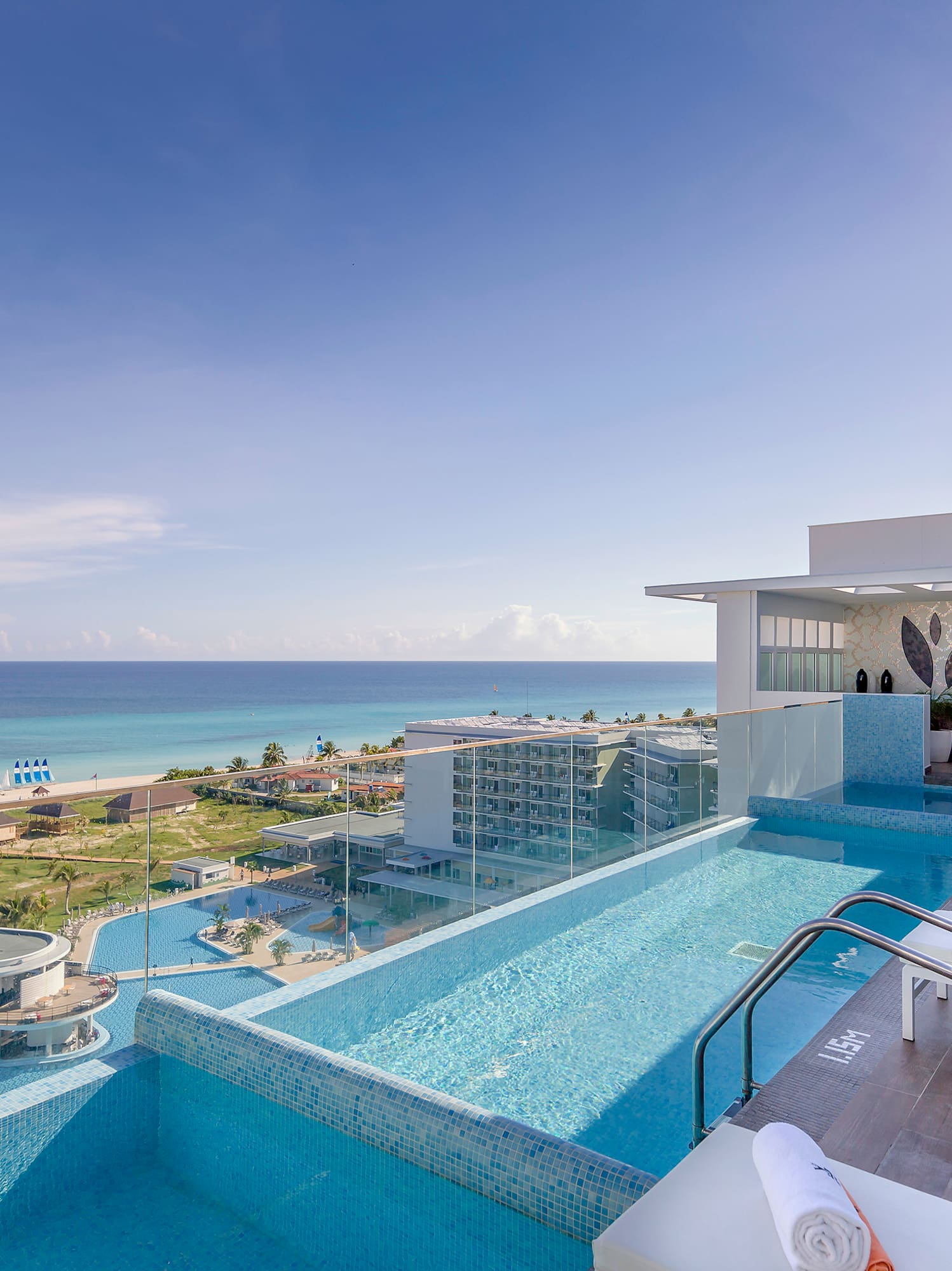 a pool with a deck and chairs on top of it